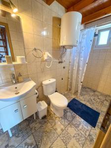a bathroom with a toilet and a sink at Seafront blue in Áyios Spirídhon +37 photos
