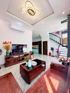 a living room with a table and a tv at weolhouse in Hue