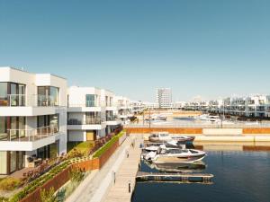a group of boats docked in a marina with buildings at Lighthouse View - Sol Marina in Wiślinka