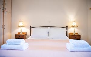 a bedroom with a bed with two pillows on it at Yasmin House in Perdika