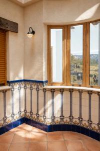 a room with windows and a balcony with a view at Alojamientos El Cañico in Moratalla