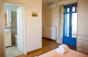 a bathroom with a blue door and a sink at Yasmin House in Perdika +52 photos