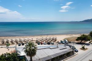 an aerial view of a beach with cars and umbrellas at Seafront blue in Áyios Spirídhon