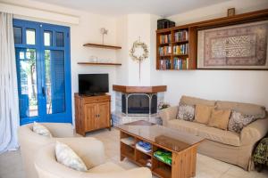 a living room with a couch and a fireplace at Yasmin House in Perdika