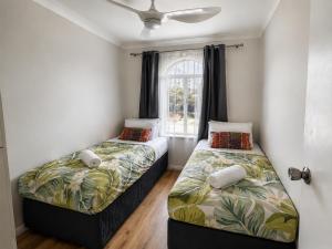 two beds in a room with a window at West Beach Lagoon 123 - Location & Views!!! in Perth +44 photos