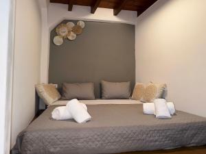 a bedroom with a bed with white pillows at Rhodes Central Apartment in Rhodes Town