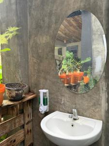 a bathroom with a sink and a mirror at ak Hostel selayar in Benteng