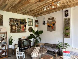 a living room with a couch and a tv at ak Hostel selayar in Benteng