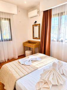 a bedroom with a bed with towels on it at Ostria Beach House in Órmos Marathokámpou