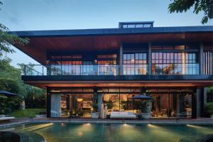 a house with a pool in front of it at Villa Suki in Canggu