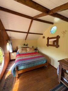 a bedroom with a bed in a attic at Tyluna Cornish Glamping Cabin in Praze an Beeble