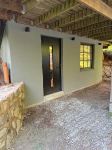 a house with a black door on the side of it at Cozy Modern Basement in Rättvik in Rättvik