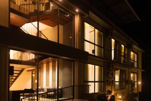 a building with a lot of windows at night at Kayn by spynora in Vythiri