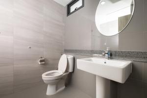 a bathroom with a toilet and a sink and a mirror at 101 Residence in Amphoe Phra Khanong +4 photos