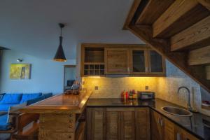 a kitchen with wooden cabinets and a counter top at Sapa mến khách sapa jade hill in Lao Cai
