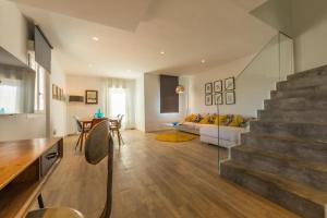 a living room with a staircase and a couch at Caracolas Luxury House in Tarifa