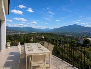 a table and chairs on a balcony with a view at Villa Muvra in Ajaccio
