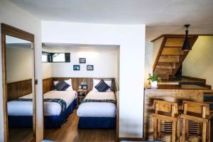 a bedroom with two beds and a staircase in it at Sapa mến khách sapa jade hill in Lao Cai