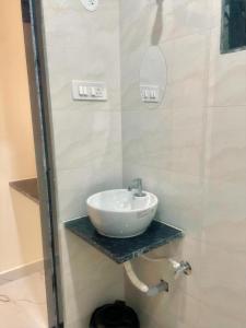 a bathroom with a white sink on a shelf at Silver Shark Boutique Villas in Ajgaon