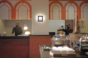 two chefs standing in a kitchen preparing food at Kata Sea Breeze Resort - SHA Plus in Kata Beach +103 photos