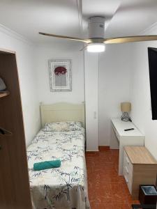 a small bedroom with a bed and a desk at GERMANIES HOME y Garaje , Algemesí Home in Algemesí