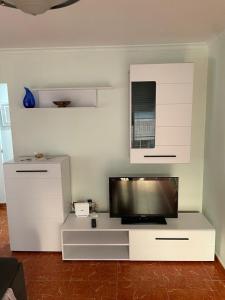 a white entertainment center with a flat screen tv at GERMANIES HOME y Garaje , Algemesí Home in Algemesí