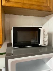 a microwave oven sitting on top of a counter at GERMANIES HOME y Garaje , Algemesí Home in Algemesí +33 photos