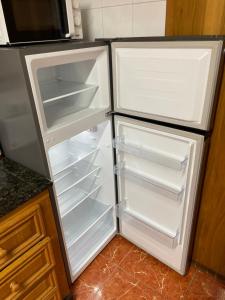 an empty refrigerator with its door open in a kitchen at GERMANIES HOME y Garaje , Algemesí Home in Algemesí