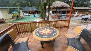 a patio with a table and chairs on a balcony at Loop Tribe - Social Hostel in Ha Giang +20 photos