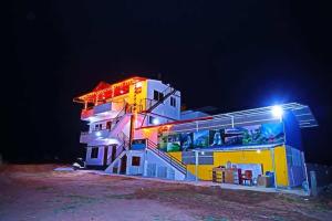 a building with lights on it at night at Loki guest House in Chikmagalūr