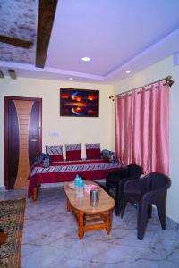 a living room with a couch and a table at Loki guest House in Chikmagalūr