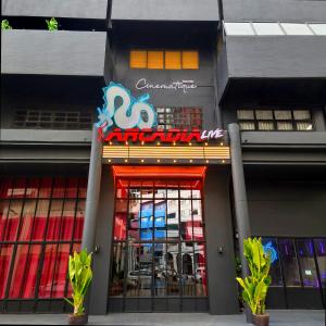 a store front with a red door and a sign at Cinematique Boutique Cinema Hotel in Bangkok