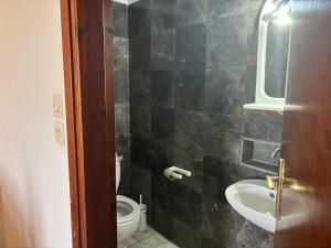 a bathroom with a sink and a toilet at Vila Theodora in Myrties