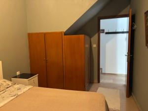 a bedroom with a bed and a closet and a door at Vila Theodora in Myrties