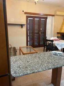 a kitchen with a counter top and a table at Vila Theodora in Myrties +2 photos