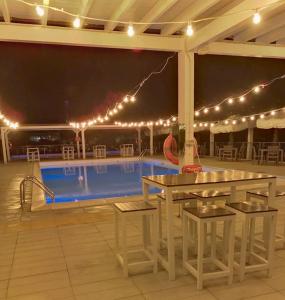 a patio with a table and a swimming pool at Appartamento Fronte Mare con ombrellone e sedie sdraio incluse nel costo in Pescara