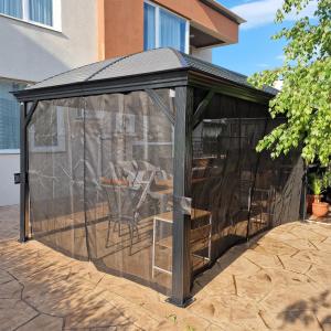 a gazebo with a table in it at Ferano Beach Apartments in Nesebar +19 photos