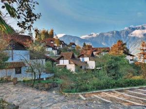 a village in the mountains with mountains in the background at Sapa mến khách sapa jade hill in Lao Cai +6 photos