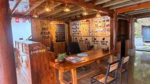 a wooden room with a wooden table and chairs at Loop Tribe - Social Hostel in Ha Giang