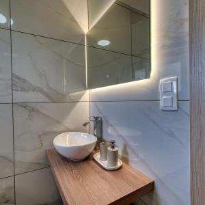 a bathroom with a white sink and a mirror at Apartments Saint Thomas in Selca +56 photos