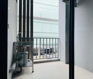 a view from a room with a balcony with a window at 101 Residence in Amphoe Phra Khanong
