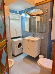 a bathroom with a sink and a washing machine at La Dolce Vita in Pisa
