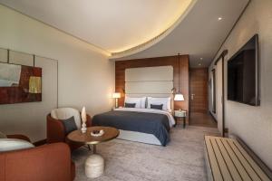 a hotel room with a bed and a couch at Monte Mulini Adults Exclusive Hotel by Maistra Collection in Rovinj