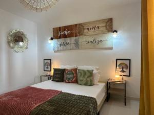 a bedroom with a bed and a sign on the wall at Ar Doce in Portel