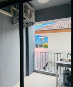 a balcony with a view of a patio at 101 Residence in Amphoe Phra Khanong