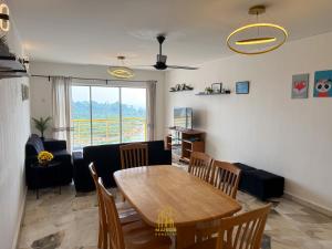 a living room with a table and a couch at BayView Suites Port Dickson By MAISON in Port Dickson