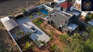 an overhead view of a house with a car on the driveway at Sky Haven Resort - Private Pool Villa near ECR in Kottaikadu