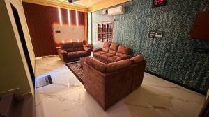 a living room with two chairs and a couch at Sky Haven Resort - Private Pool Villa near ECR in Kottaikadu