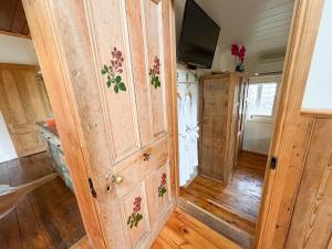 a room with a wooden door with a tv on it at Gladstone House in Beechworth