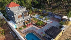 an overhead view of a house with a swimming pool at Sky Haven Resort - Private Pool Villa near ECR in Kottaikadu